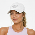 Woman wearing a white cap with a logo on a plain background